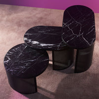 Black marble coffee tables with white veining, featuring a sleek modern design and curved shapes. Perfect for contemporary decor.