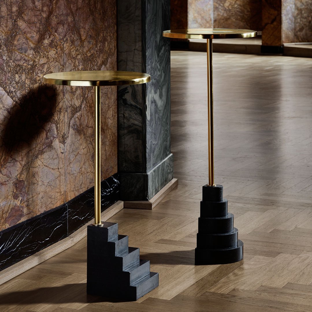 Gold and black decorative side tables with modern geometric patterns, featuring elegant step-like bases.