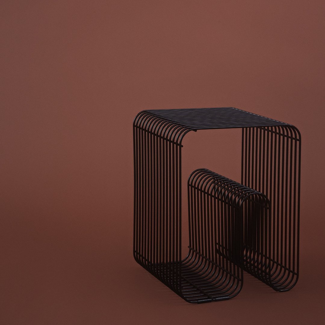 Black wireframe side table against a solid brown background, featuring sleek lines and minimalist design.