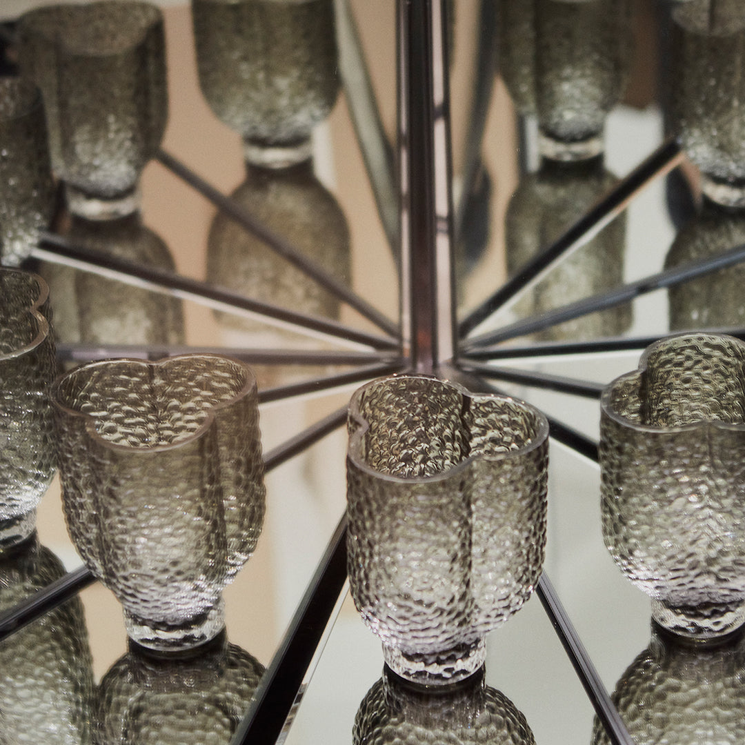 "Textured gray glass cups with a reflective surface, showcasing unique patterns and elegant design."