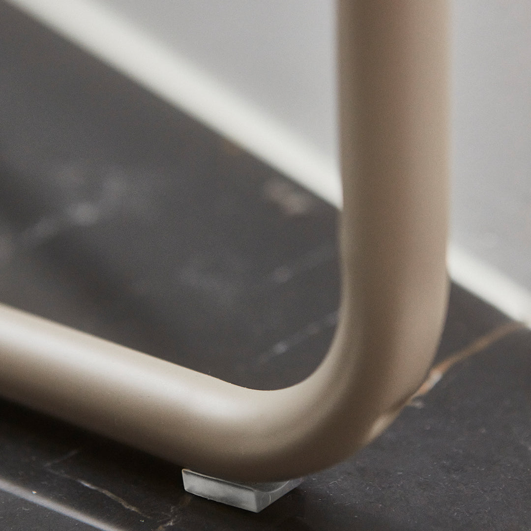 "Smooth beige frame with subtle curvature, resting on a contrasting dark surface."