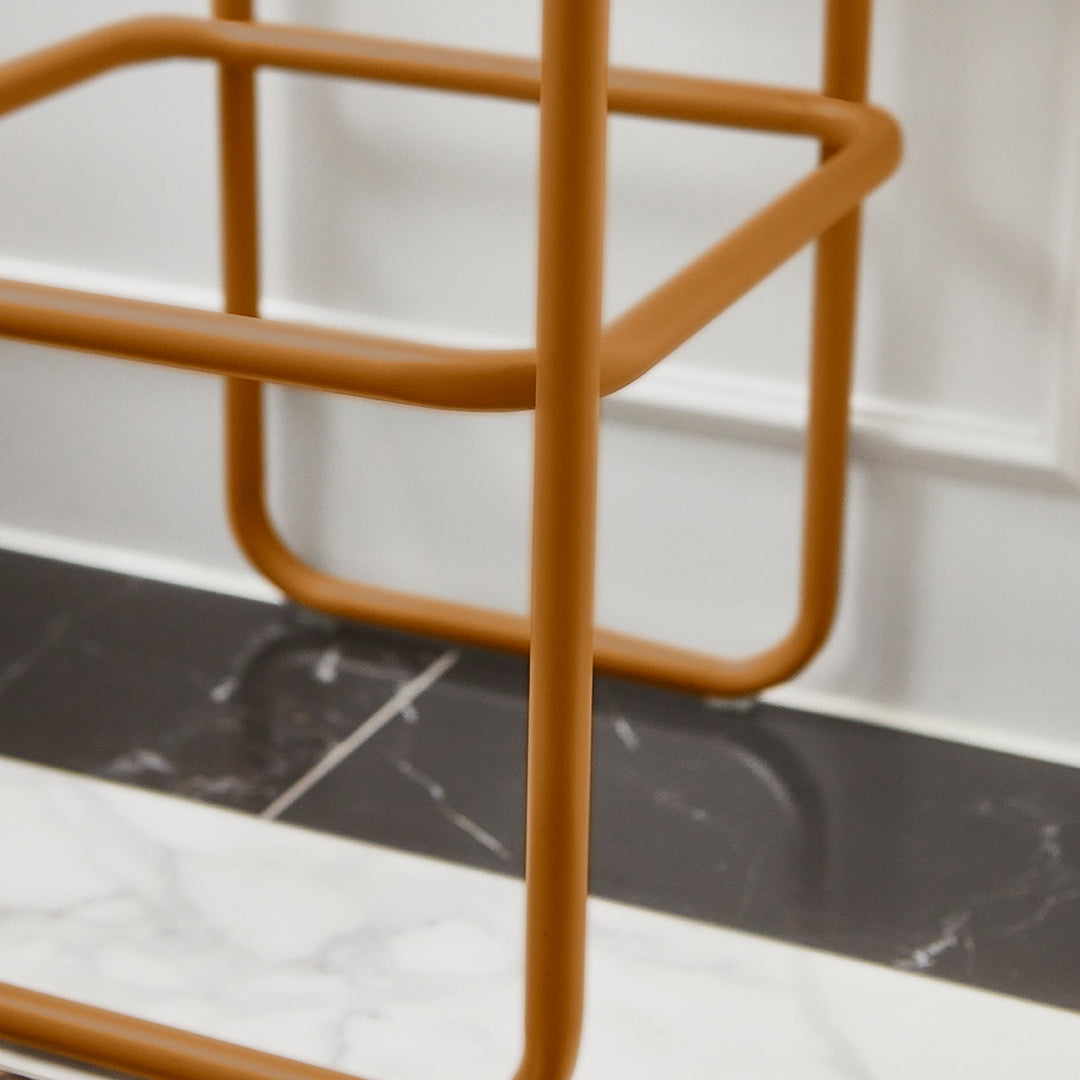 Orange metal frame on black and white marbled floor with clean lines and modern design. Perfect for stylish decor.