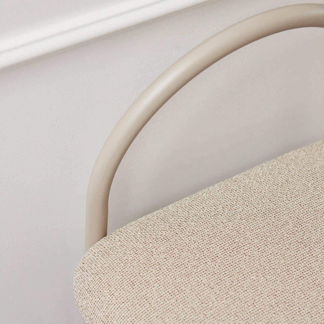 Beige fabric seat with a smooth tan metal frame, showcasing a subtle textured pattern for a modern aesthetic.