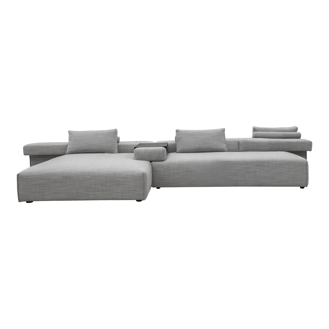 Gray sectional sofa with a modern design and soft textured fabric, featuring minimalistic pillows and clean lines.