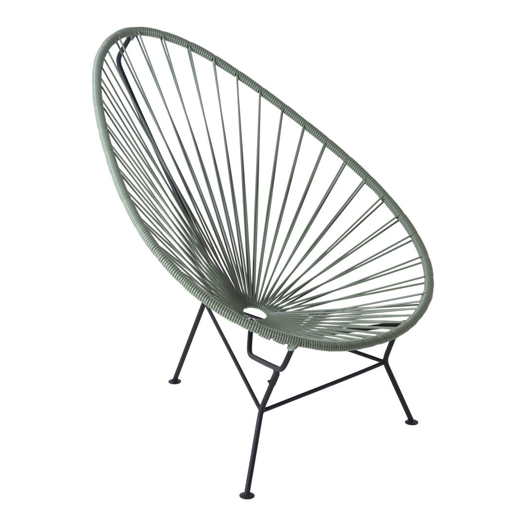 Green Acapulco chair with a round, open weave pattern and black metal legs, perfect for modern outdoor decor.