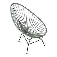 Green Acapulco chair with a round, open weave pattern and black metal legs, perfect for modern outdoor decor.