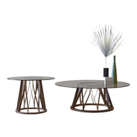 Set of two round coffee tables with sleek glass tops and geometric wood bases in rich brown tones.