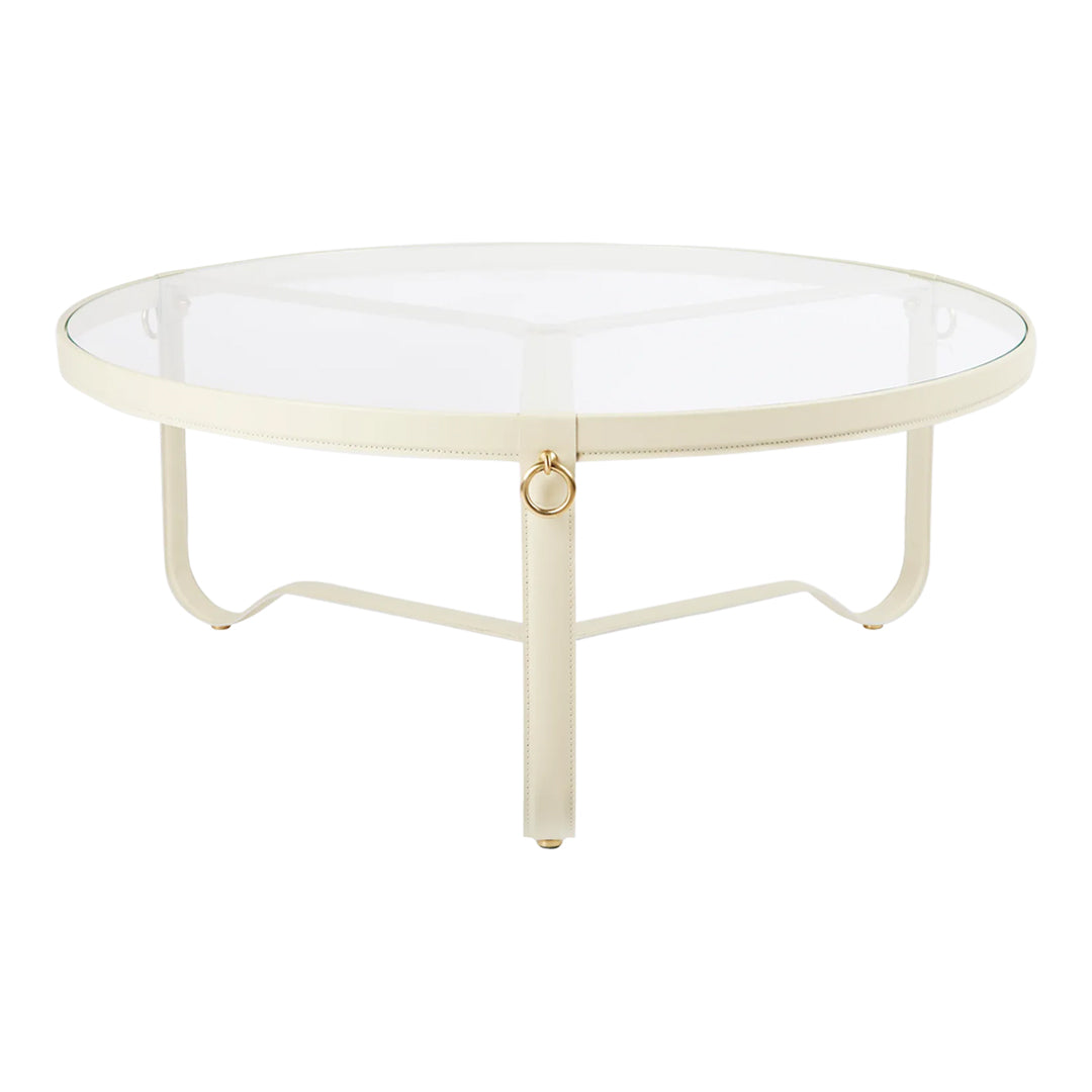 Circular coffee table with a glass top and cream-colored metal frame, featuring sleek, modern lines.