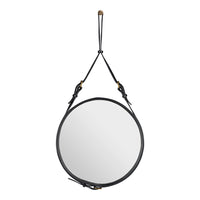Black circular mirror with a sleek leather strap and brass accents, showcasing a minimalist design.