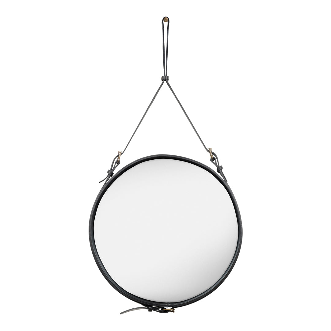 Round wall mirror with a sleek black leather strap and brass accents, featuring a minimalist design.