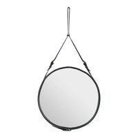 Round mirror with a sleek black leather frame and minimalist hanging strap, perfect for modern decor.