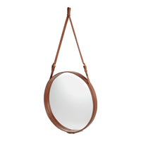Brown leather strap hanging round mirror with a simple, modern design against a white background.
