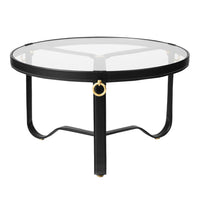 Round coffee table with a sleek black metal frame and a clear glass top, featuring elegant gold accent details.
