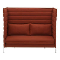 Rust orange two-seater sofa with vertical stitched pattern and plush cushions, set on sleek metal legs.