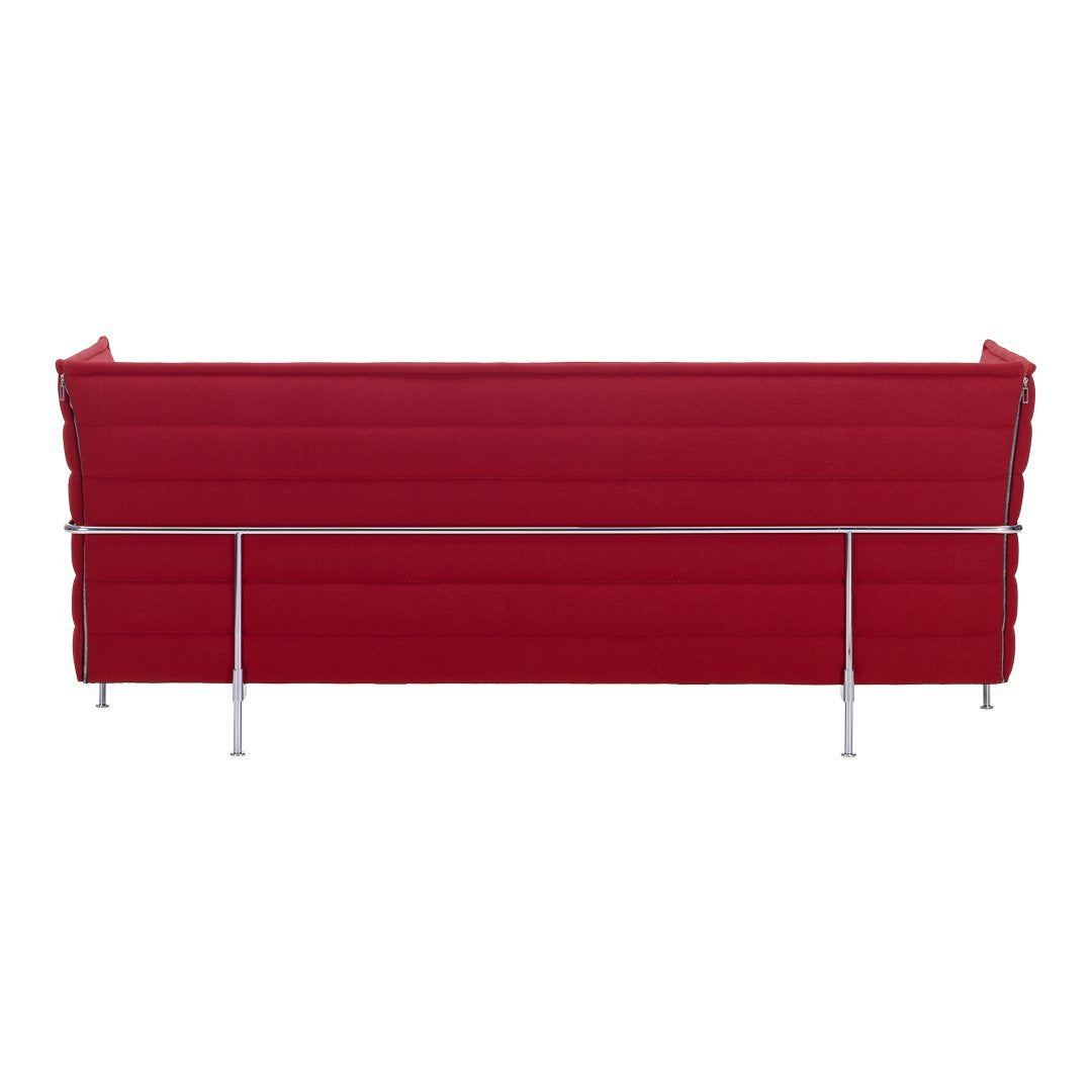 Red tufted sofa with sleek chrome legs, featuring a modern, minimalistic design. Perfect for any contemporary space.