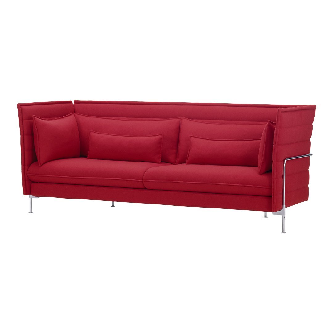 Bright red sofa with a sleek design and plush cushions, featuring a smooth fabric texture and modern chrome legs.