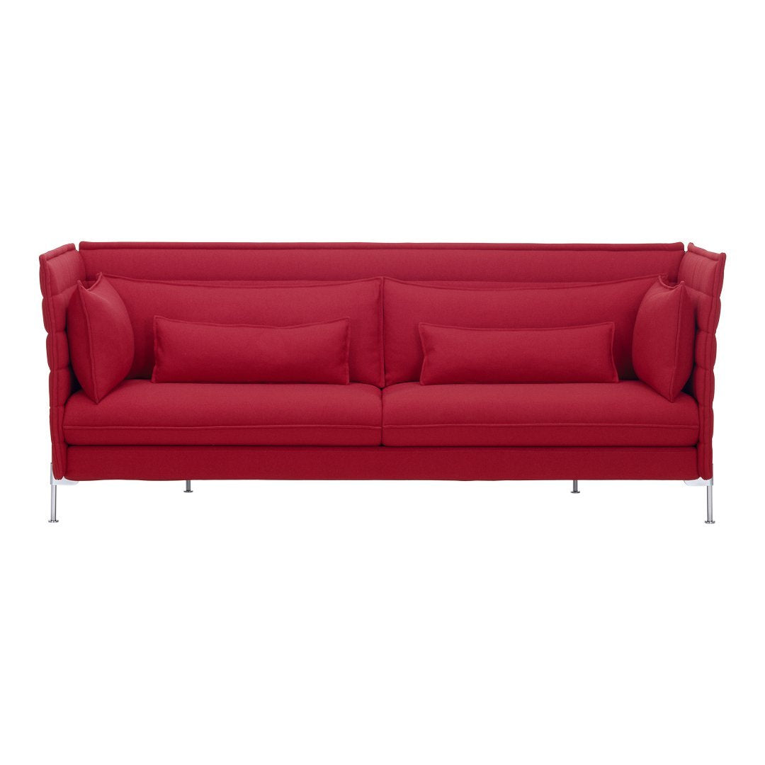 Bright red sofa with modern, textured upholstery and matching throw pillows, featuring sleek metallic legs.