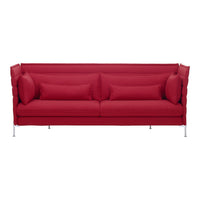 Bright red sofa with modern, textured upholstery and matching throw pillows, featuring sleek metallic legs.