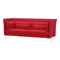 Vibrant red sofa with smooth fabric and sleek silver legs, featuring a minimalist design and plush cushions.