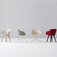 Four modern chairs in cream, gray, white, and bold red, showcasing sleek designs and vibrant colors against a minimalist backdrop.