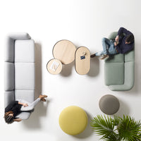 Modern seating in soft gray and green tones, paired with light wood and vibrant yellow and gray accents, minimalistic design.