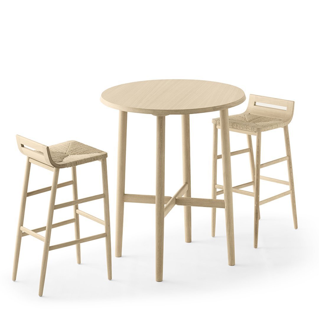 Light natural wood round table with matching stools, featuring a smooth finish and minimalist design.