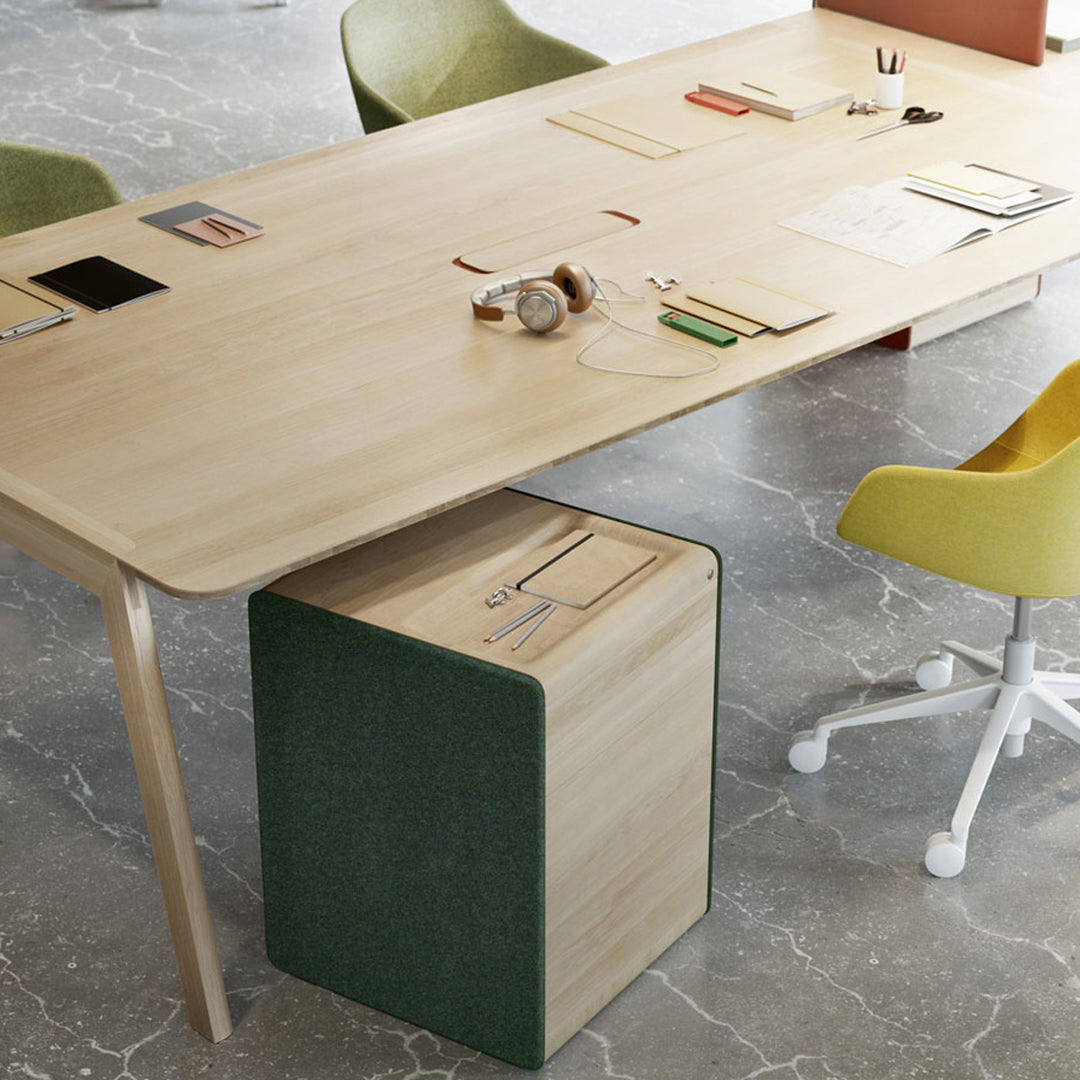 "Light wood desk with green and yellow accents, featuring smooth surfaces and minimalist design in a modern workspace."