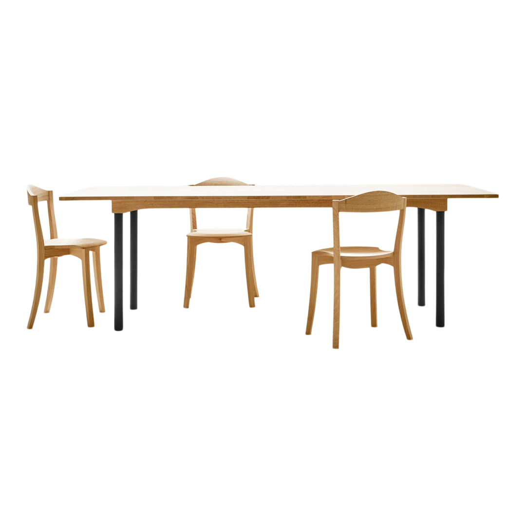 Natural wood dining table with black metal legs, accompanied by matching wooden chairs in a simple, minimalist design.