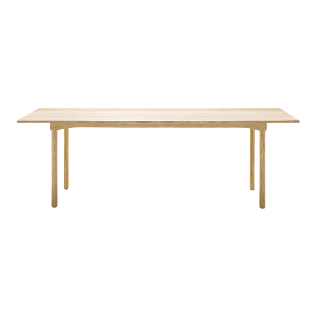 Light wood dining table with a smooth, plain surface and simple, natural finish, ideal for modern interiors.