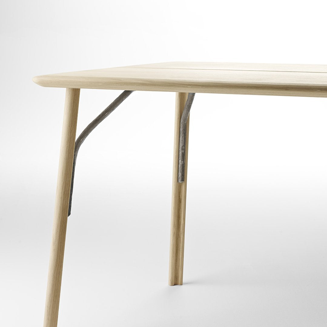 Light beige tabletop with smooth finish, natural wood legs in a minimalist design. Ideal for modern decor.