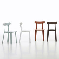 Four chairs: pastel green, crisp white, warm terracotta, and deep brown, showcasing a sleek, modern design.