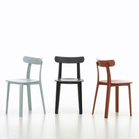 Three stylish chairs in soft blue, sleek black, and warm terracotta, featuring minimalist design and smooth finishes.