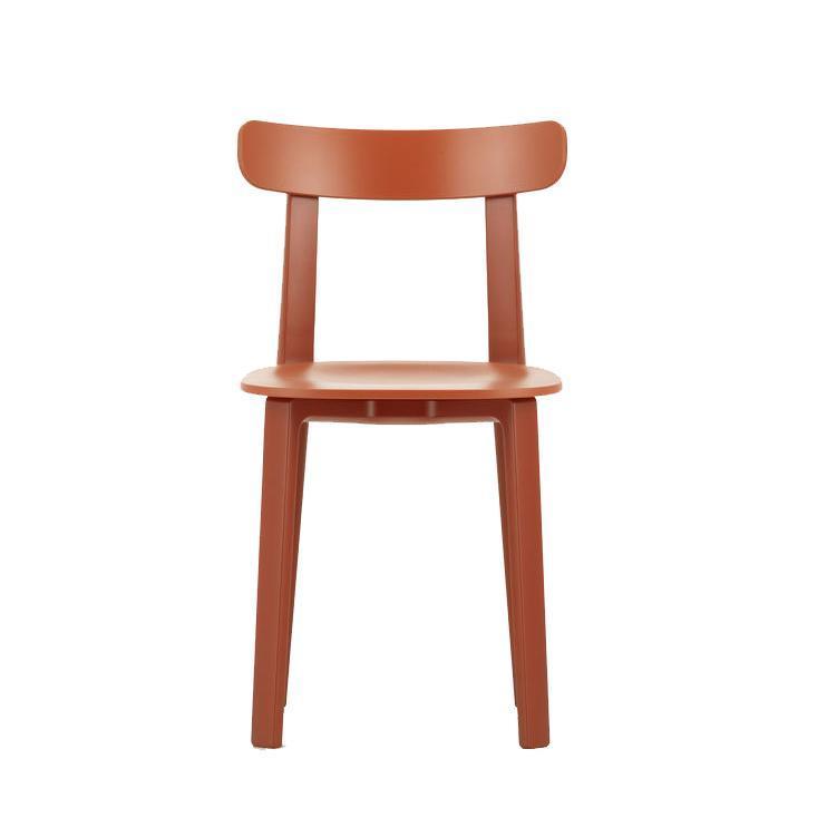 Rust-colored wooden chair with a simple, modern design and smooth finish, perfect for minimalist decor.