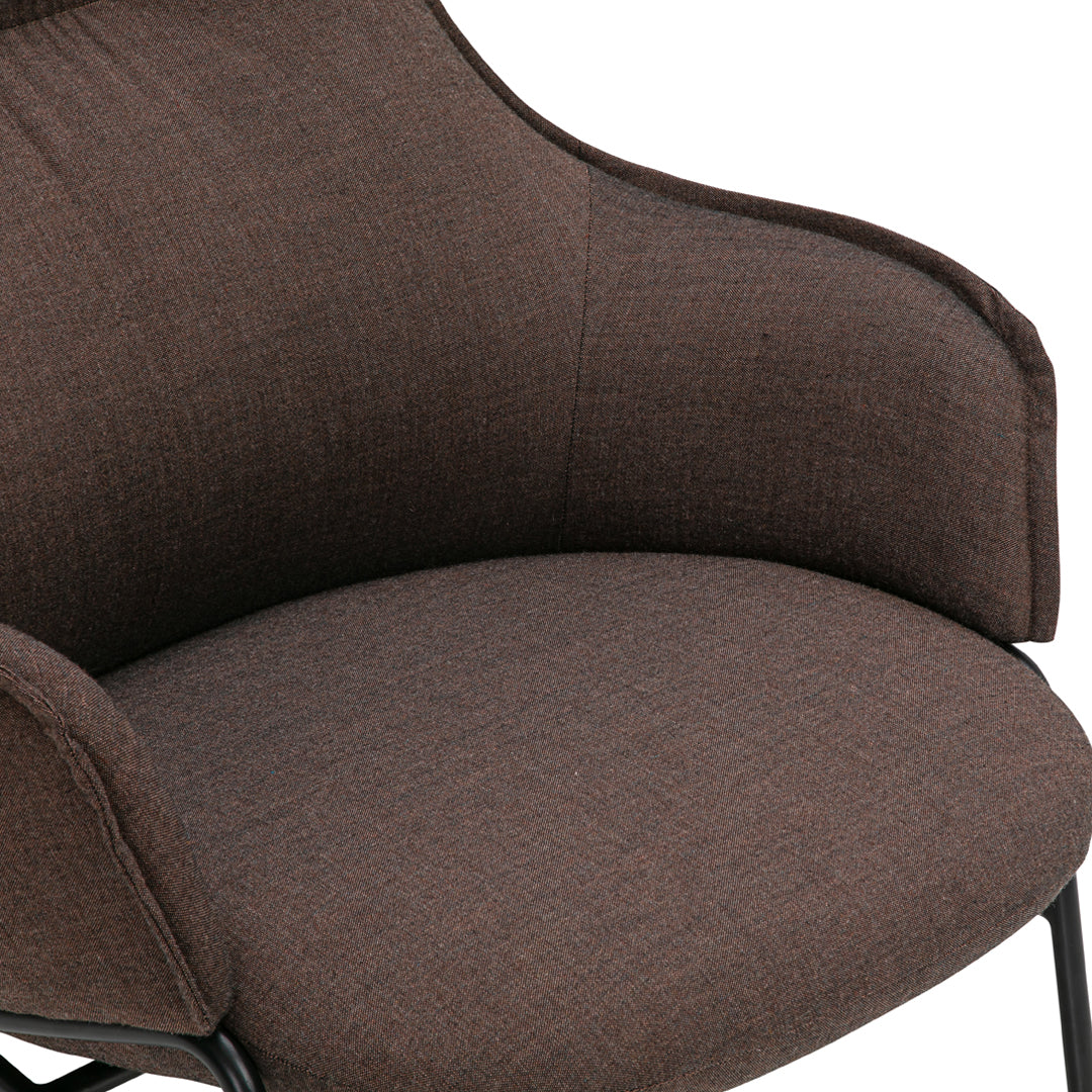 Brown textured upholstery with a smooth finish on a modern chair. Ideal for contemporary home decor.