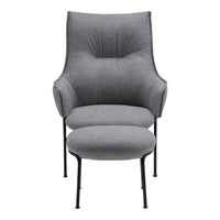 Gray upholstered armchair with smooth fabric and minimalist design, accompanied by a matching gray ottoman.