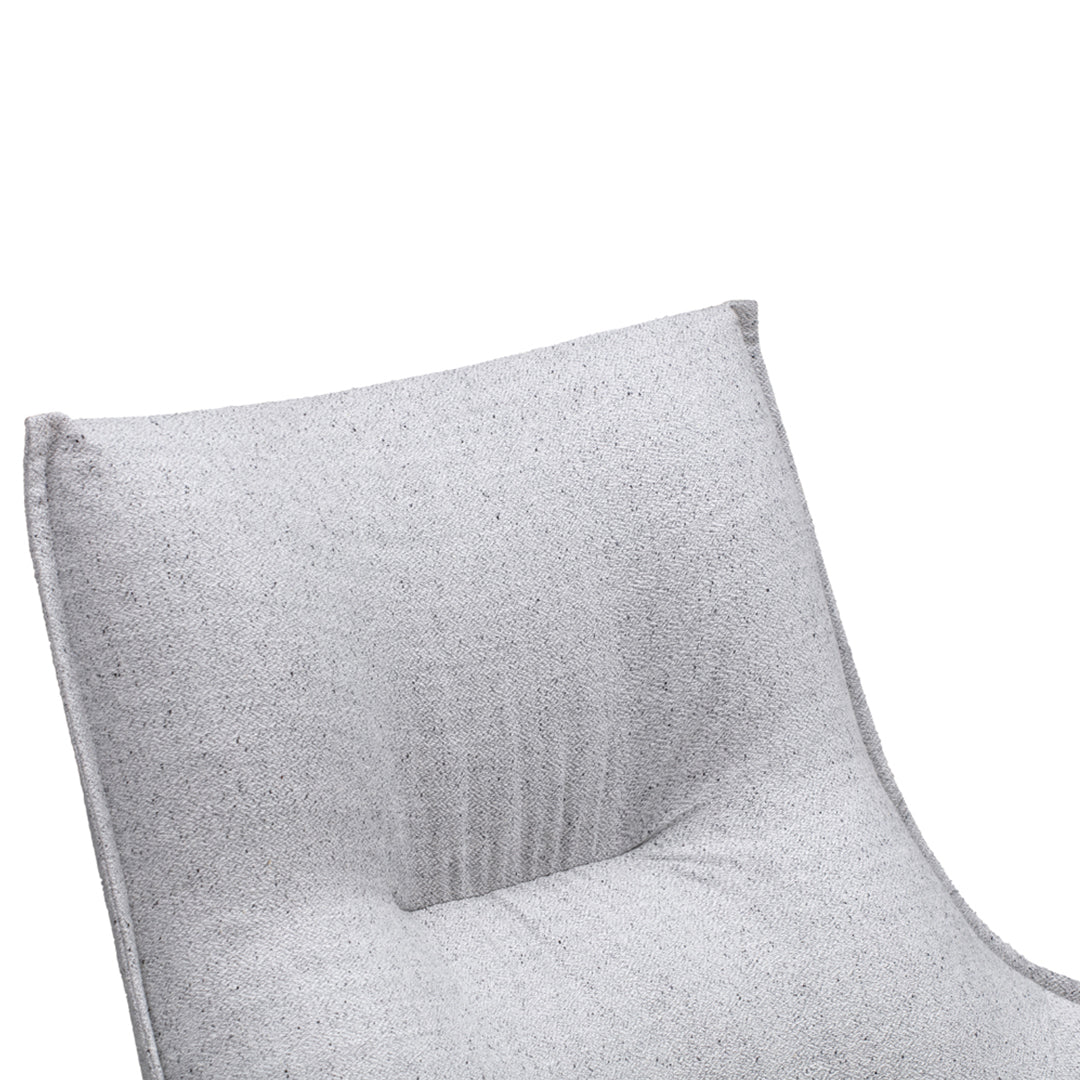 Light gray upholstered chair with a subtle textured pattern and a sleek, modern design. Ideal for contemporary decor.