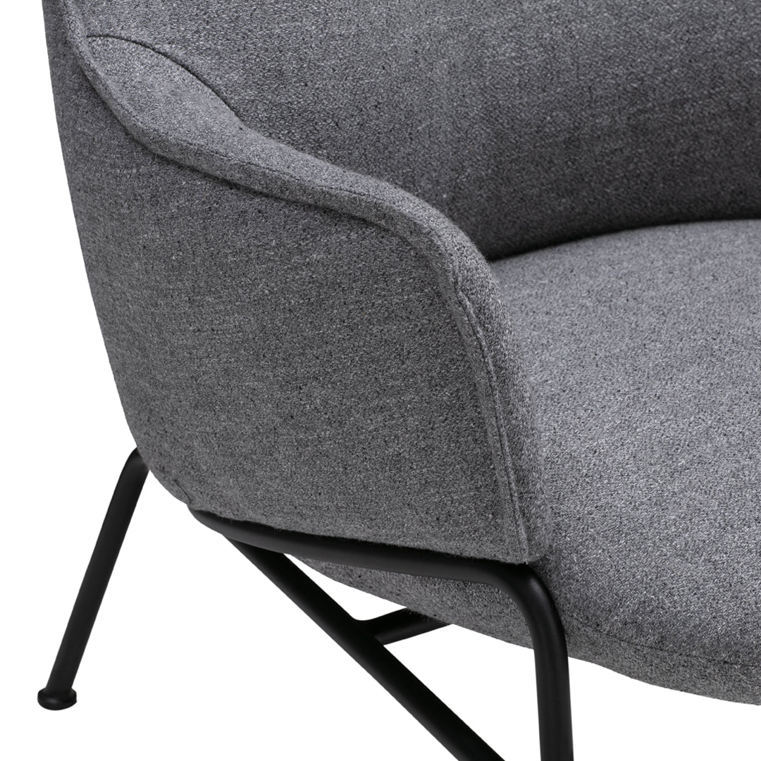 Gray upholstered chair with a subtle texture, featuring sleek black metal legs. Ideal for modern interiors.
