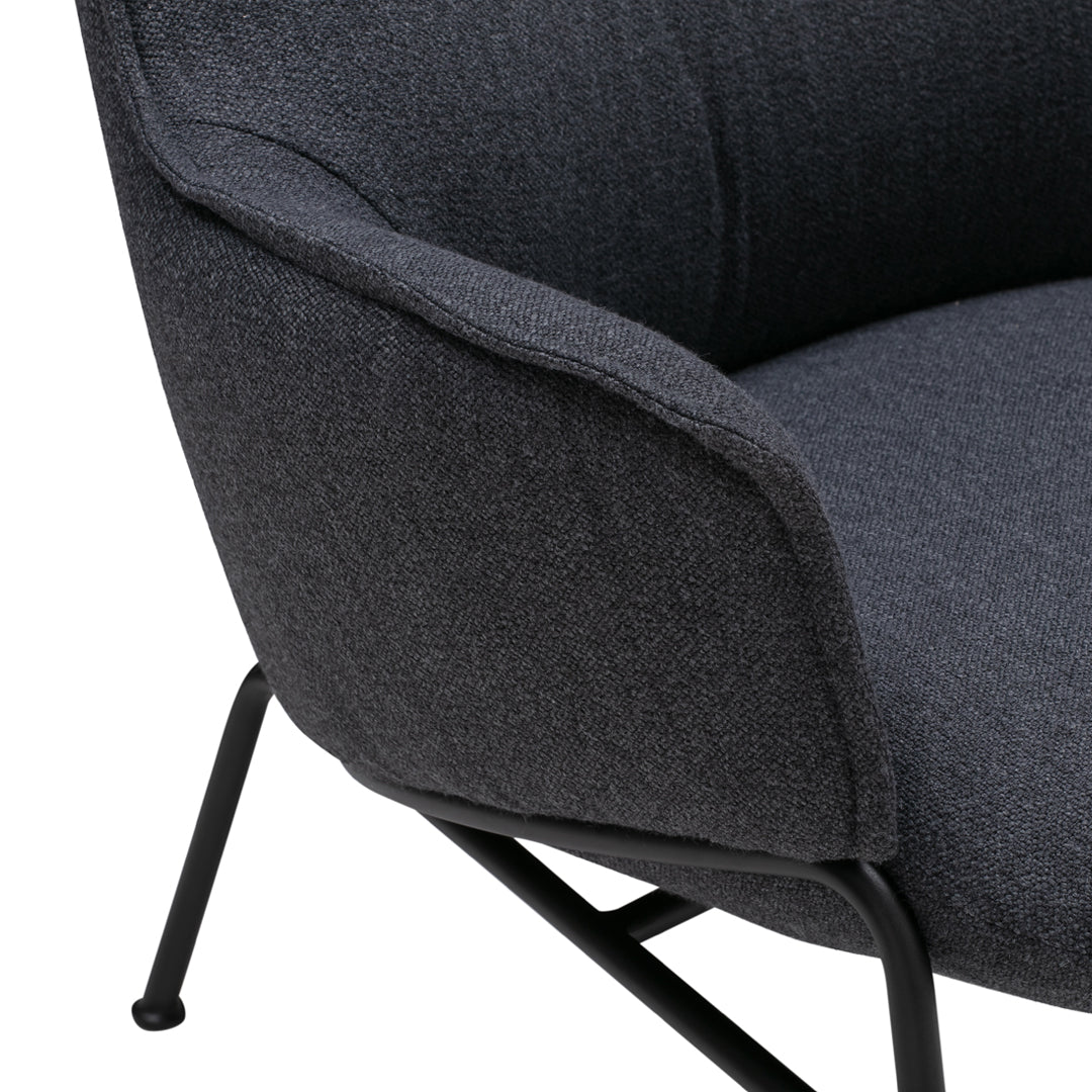 Stylish gray upholstered lounge chair with a smooth texture and sleek black metal legs. Perfect for modern decor.
