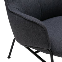 Stylish gray upholstered lounge chair with a smooth texture and sleek black metal legs. Perfect for modern decor.