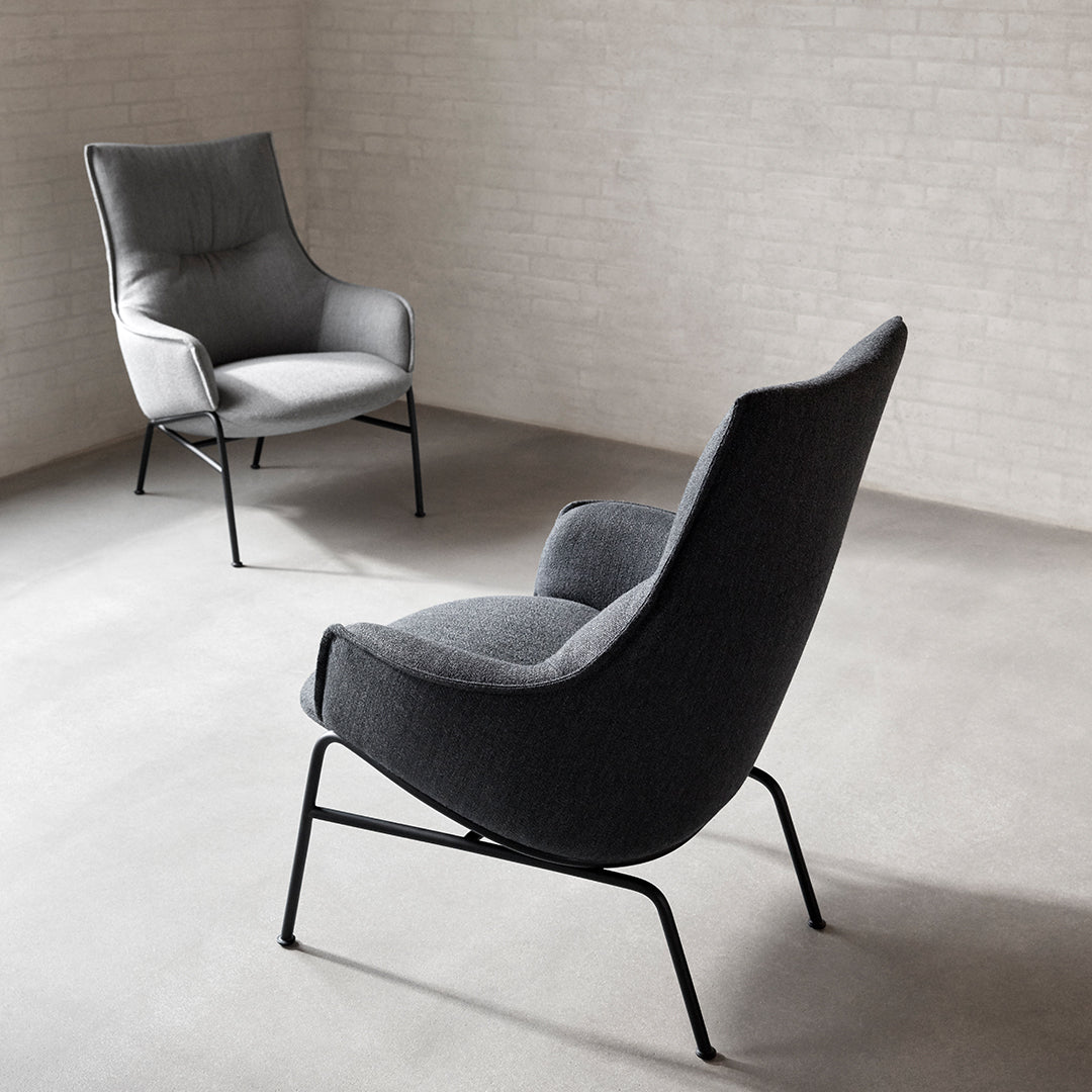 Modern lounge chairs in sleek gray upholstery with minimalist black metal legs, perfect for contemporary decor.