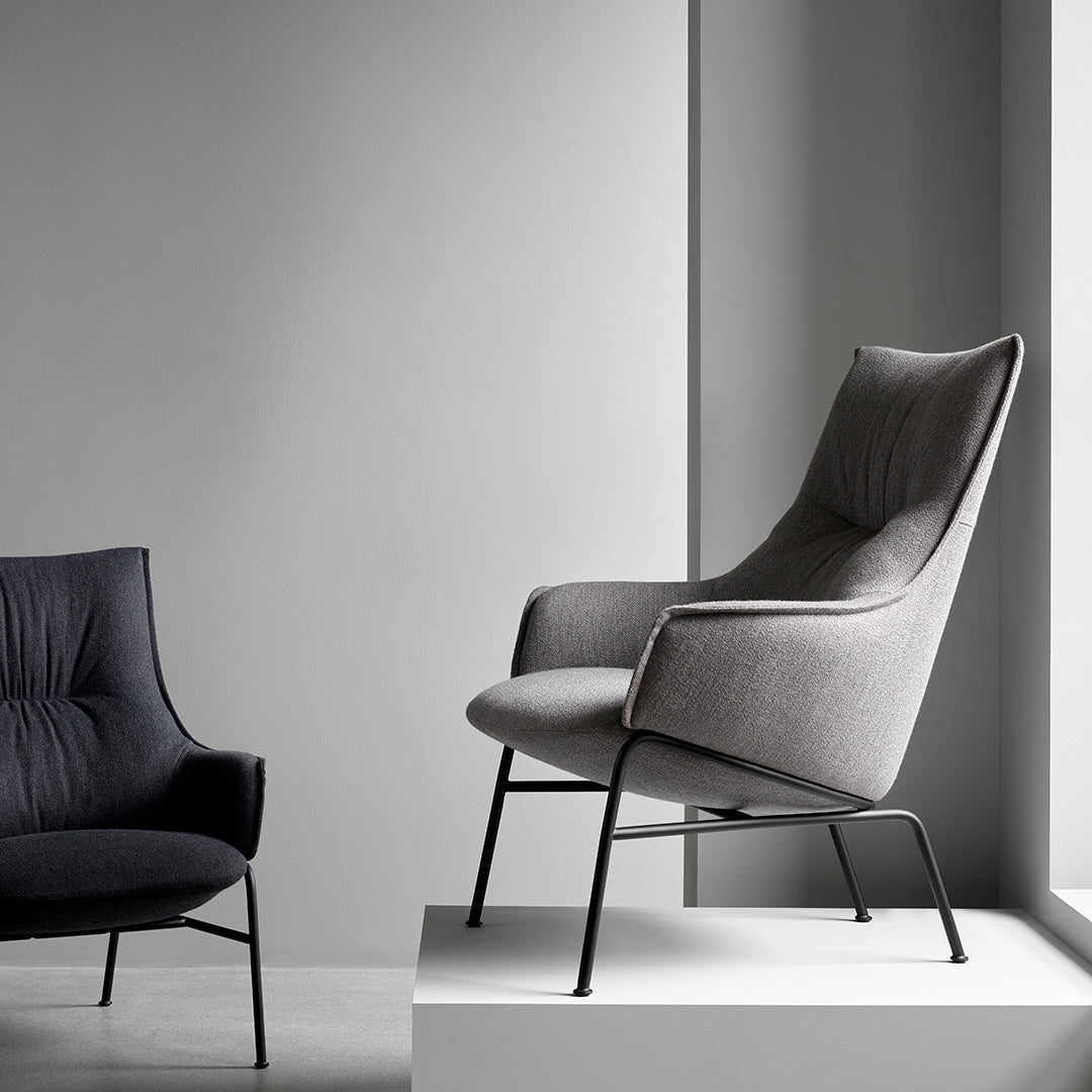 Modern gray accent chair with subtle tufted pattern and sleek black metal legs, perfect for contemporary interiors.