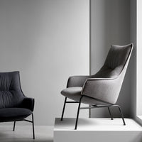 Modern gray accent chair with subtle tufted pattern and sleek black metal legs, perfect for contemporary interiors.