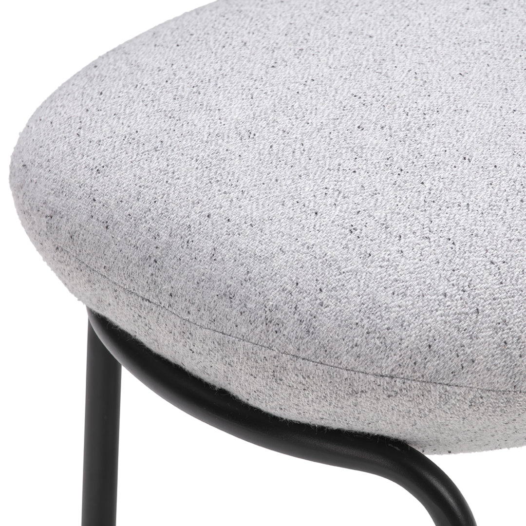 Gray speckled fabric cushion with a sleek black metal frame, perfect for modern decor.