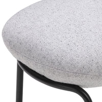 Gray speckled fabric cushion with a sleek black metal frame, perfect for modern decor.