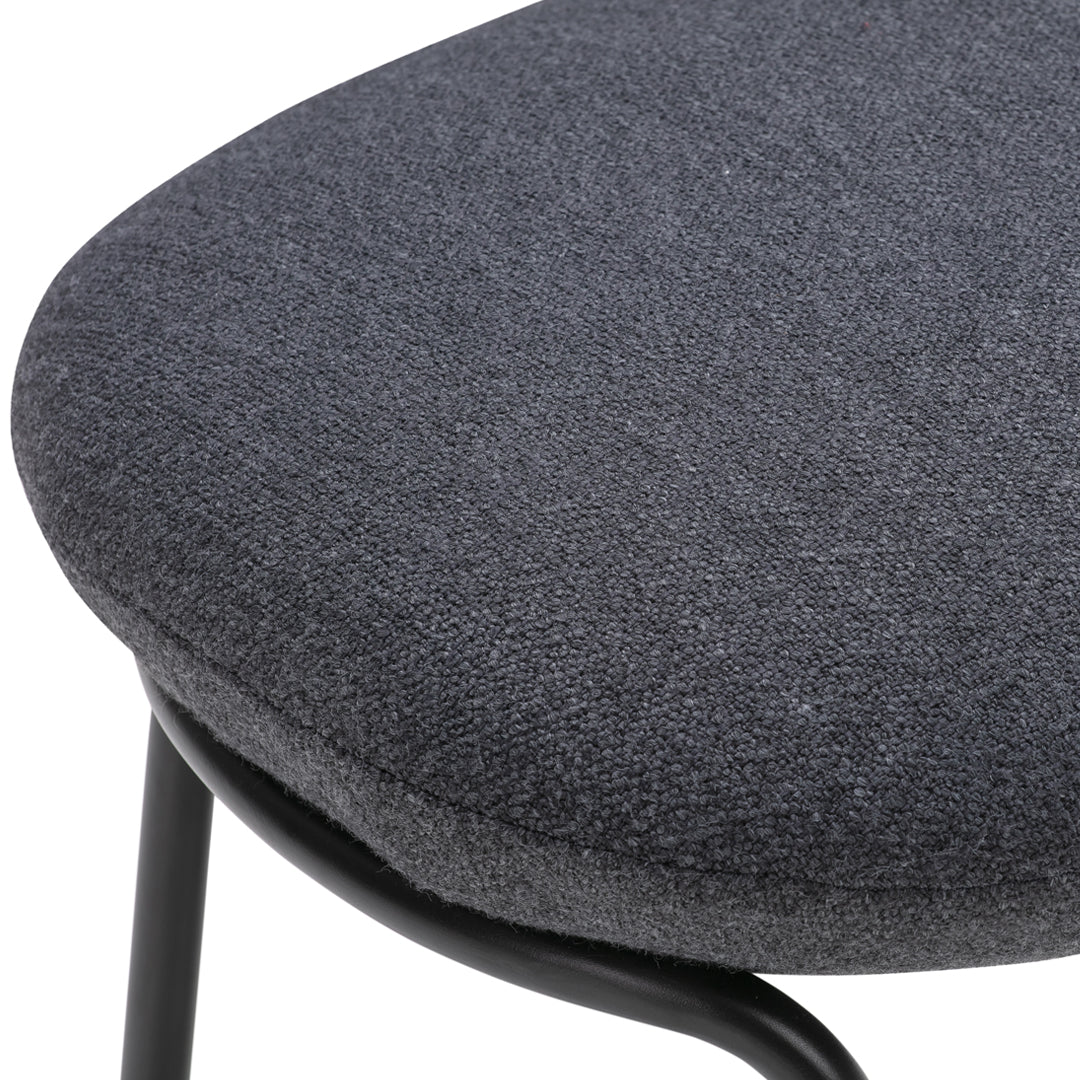 Gray textured fabric upholstery on a modern chair, highlighting a sleek, minimalist design.