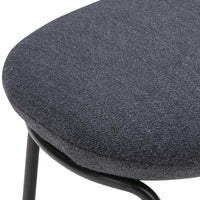 Gray textured fabric upholstery on a modern chair, highlighting a sleek, minimalist design.