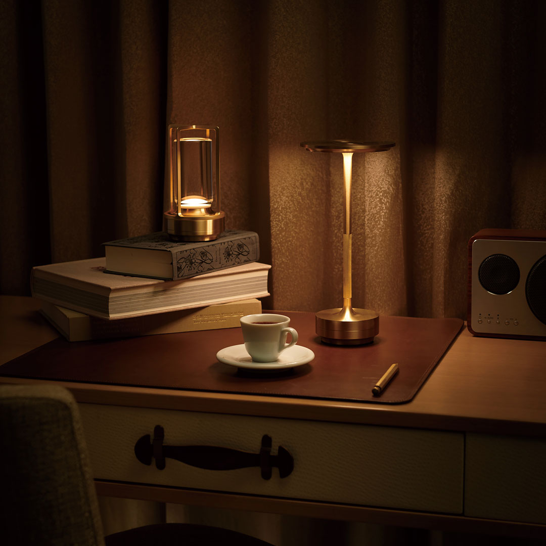 Elegant gold accents and rich brown tones create a cozy, stylish desk atmosphere with soft lighting.
