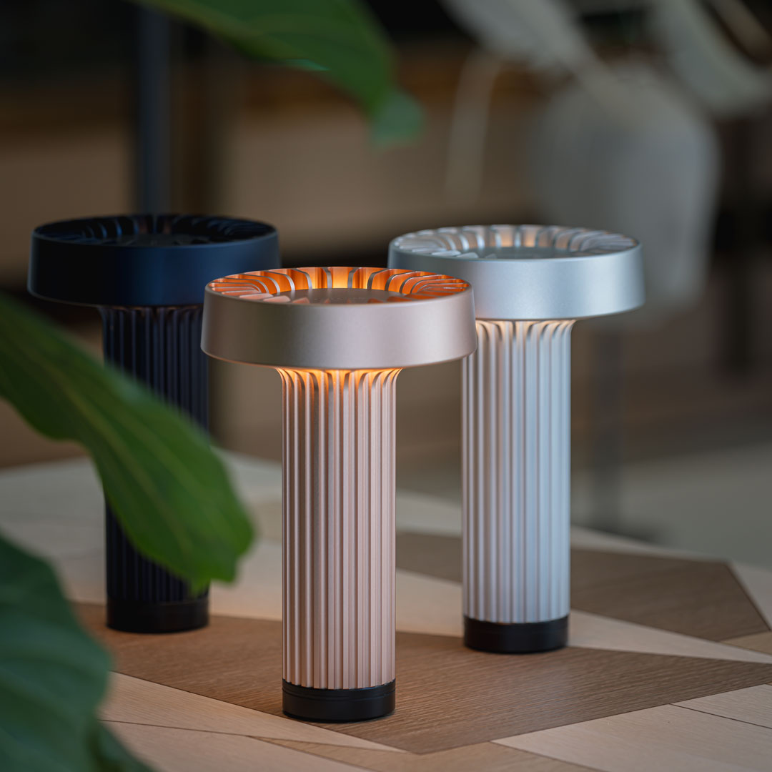 Three stylish lamps: black, rose gold, and silver with ribbed patterns, enhancing modern decor.