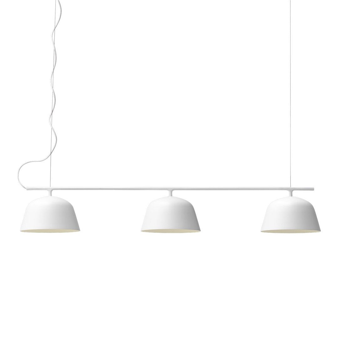 Three sleek white pendant lights with smooth, curved, matte finish shades. Minimalist design with subtle elegance.