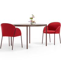 Red upholstered chairs paired with a round wooden table, featuring a clean, modern design. Perfect for contemporary dining spaces.